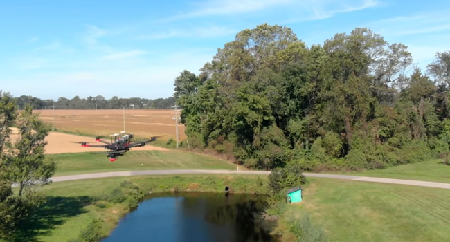 Drone flying over irrigation pond near production fields.