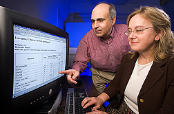 David Haytowitz and Pamela Pehrsson view computer screen displaying the lab's online search program. Link to photo information