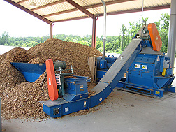 Photo: A large machine processes woodchips into potting medium. Link to photo information