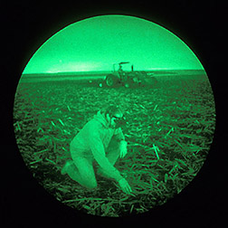 Aided by night vision scopes, technician Keith Kohler checks soil conditions.