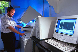 Curtis Van Tassell loading high-capacity DNA sequencer.