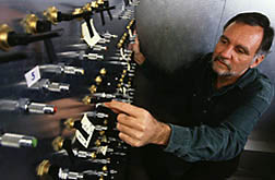 Technician Willard Douglas adjusts the valves of a multigas mixture unit.