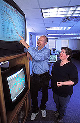 Photo: Hydrology engineer Jurgen Garbrecht and meteorologist Jeanne Schneider interpret the latest seasonal climate forecast issued by NOAA's Climate Prediction Center. Link to photo information