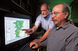 George Mueller-Warrant and Jerry Whittaker view watershed map on computer screen. Link to photo information