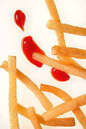 Photo: A pile of French fries with some ketchup dabs next to them. Link to photo information