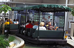 Tourists take a boat ride past an ARS biotechnology lab in The Land exhibit at Epcot.
