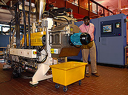 Charles Onwulata stands beside machinery that is part of the pilot plant. Link to photo information