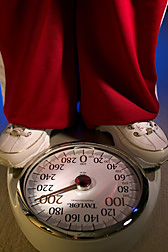 Closeup of a weight scale that tops 200 pounds, along with the feet of the person standing on it. Link to photo information