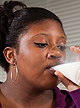 A woman drinking a glass of milk