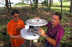 Dan Kline (left) and Gene Lemire inspect a rotator surveillance trap.