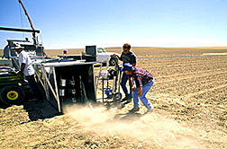 Agricultural engineer and technicians use a portable wind tunnel to test field surface susceptibility to wind erosion and PM-10 emissions. 
