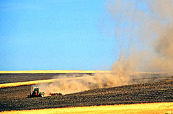 Dust stirred up by field tillage.