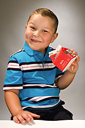 Photo: Young boy with milk carton. Link to photo information