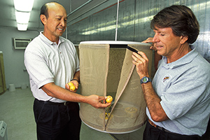 Dennis Gonsalves and entomologist Roger Vargas expose fly-infested guavas to parasitic wasps.