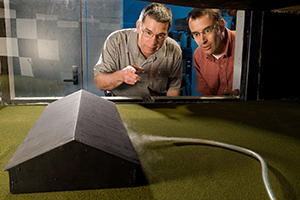 Jerry Hatfield and Tom Sauer use smoke to help them observe airflow patterns inside the wind tunnel.