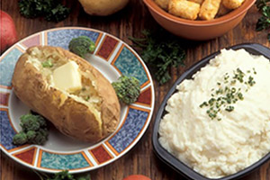 A baked potato and mashed potatoes
