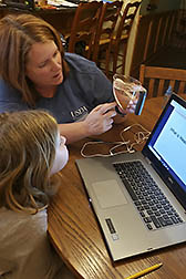 Mother and daughter perform a science activity involving erosion by water