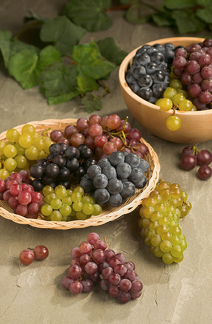 Bunches of red, purple, green and black grapes.