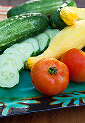 Sliced cucumbers, yellow squash and tomatoes