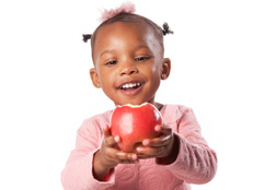 D3772-1: Little girl holding an apple