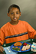 Boy holding lunch tray with a school meal.