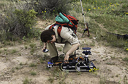 Grad student, Sonia Roberts performs field testing with the (RHEX) robot hexapod.