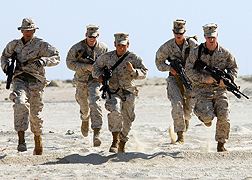 Photo: Five U.S. marines in desert uniforms running.