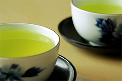 Photo: Two teacups filled with green tea. 