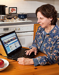 Photo: A woman using a laptop to access the nutrient database. Link to photo information
