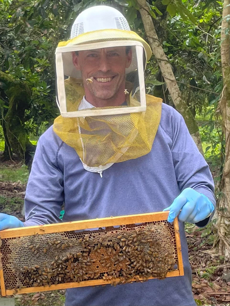 Jay Evans holding a bee frame.