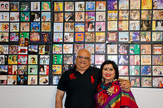 Dr. Biswas (left) and his wife (right) pictured with Biswas Records CD covers.